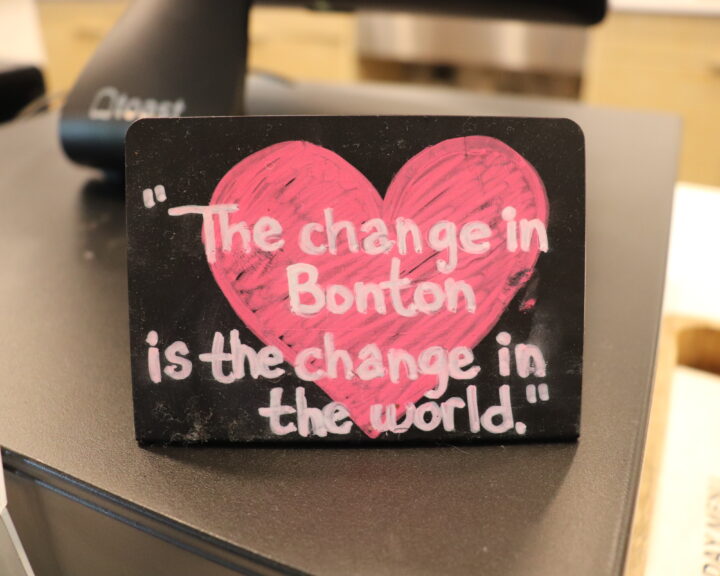 Placard that shows the motto of Bonton Farms. It states, "The change in Bonton is the change in the world"